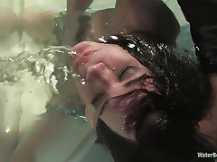 The executor doesn't wants to play only with her pussy, he wants to fuck her mind too. After he tied this milf with heavy chains he putted her in that water tank and fingered her shaved pussy. Now that the guy is bored with her he just drowns the fucking slut, just for fun...